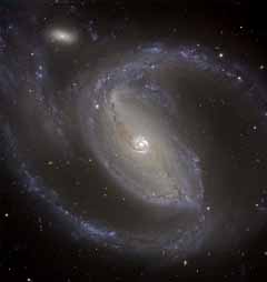 Imagen de la galaxia espiral NGC 1097 y su compañera NGC 1097A, tomada en el VLT con el instrumento VIMOS. Crédito:ESO